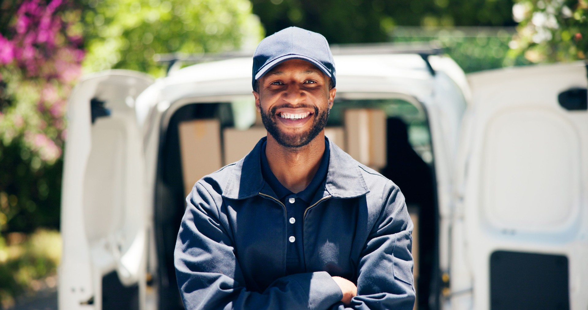 Courier, delivery man and portrait with arms crossed outdoor  for ecommerce business and supply chain. Logistics, van and black driver in export industry for package distribution and cargo service